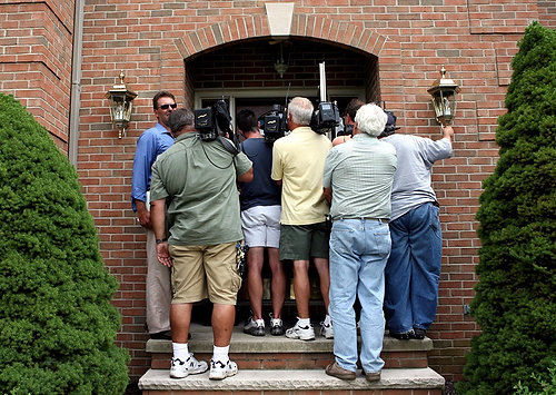 First Place, James R. Gordon Ohio Understanding Award - Lynn Ischay / The Plain DealerFederal agents swarmed over the homes and offices of Cuyahoga County politicians, and the media soon followed.  Here a throng of reporters and cameramen waited outside County Commissioner Jimmy Dimora's house in Independence.  Dimora did not address the media that day but declared his innocence in subsequent news conferences.  