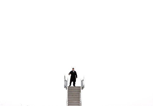 Second Place, Pictorial - Lisa DeJong / The Plain DealerA secret service agent checks the plane stairs that will connect to Air Force One at Atlantic Aviation in Cleveland. The stairs were sitting on the tarmac awaiting the arrival of President Barack Obama. 