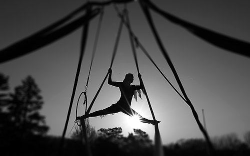 Third Place, Pictorial - Michael E. Keating / Cincinnati EnquirerAn aerialist for the Amazing Portable Circus performs outdoors at a late afternoon event. 
