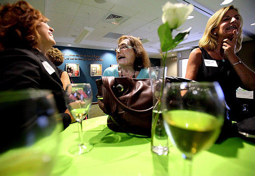 First Place, Photographer of the Year/Large Market - Lisa DeJong / The Plain DealerHer speech over and her nervousness gone, Connie Culp is back to her old self, joking with guests at a reception after the opening of LifeBanc's new offices. Connie is becoming more comfortable floating around in different social circles of people, far removed from her rural, southern Ohio home. 