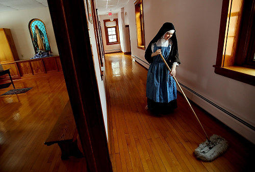 First Place, Photographer of the Year/Large Market - Lisa DeJong / The Plain DealerSister Faustina, 23, the youngest nun in the cloister who is in her twenties,  sweeps the halls every day in her cloistered living quarters.With the exception of a couple of extern nuns who run errands, answer telephone and meet with the public, the sisters never leave the convent save for medical treatment. Other contact with the outside world comes by way of the daily newspaper which is read by extern sisters.