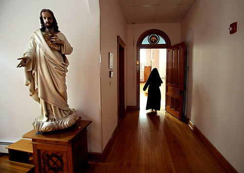 First Place, Photographer of the Year/Large Market - Lisa DeJong / The Plain DealerMother Dolores enters The Choir, a chapel in her cloistered living quarters inside the Monastery of the Blessed Sacrament.  The monastery was built in 1905 and the gleaming, spotless woodwork shows little wear. 