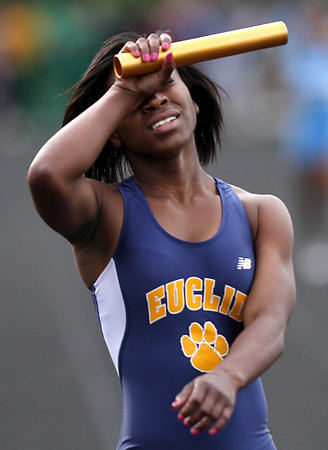 Second Place, Photographer of the Year/Large Market - Gus Chan / The Plain DealerArtia Gunn, of Euclid, holds her head in exhaustion after anchoring the girls 4X200 relay to a first place finish at the District track meet. 
