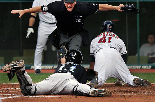 Second Place, Photographer of the Year/Large Market - Gus Chan / The Plain DealerHe's safe! That's the call by home plate ump Chad Fairchild as Indians catcher Carlos Santana slides home in the first inning, beating the tag of Toronto catcher John Buck. The Indians beat the Blue Jays, 2-1.