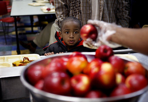 Third Place, Photographer of the Year/Large Market - Eric Albrecht / The Columbus DispatchC.J. Chapman 3 eyes a apple  before being handed to him at the Community Kitchen .As hunger needs grow for the community the Community Kitchen finds itself feeding more families.