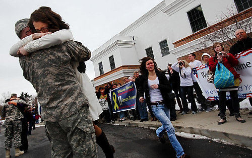 Third Place, Photographer of the Year/Large Market - Eric Albrecht / The Columbus DispatchHeather Bower embraces her husband Steve Bower while Jessica Pitzer 16 runs to greet her father Paul Pitzer .Members of the 174th Artillery Brigade had returned to a welcome home ceremony at a local church  after serving in Afghanistan.
