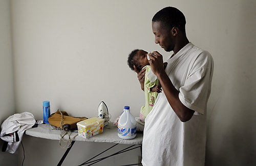 Third Place, Photographer of the Year/Large Market - Eric Albrecht / The Columbus DispatchRobert wipes the eye of his daughter Harmonie at his Columbus apartment.Adoption and abortion are often ruled out with young teenagers from these circumstances because they want to be the kind of parents they never had.