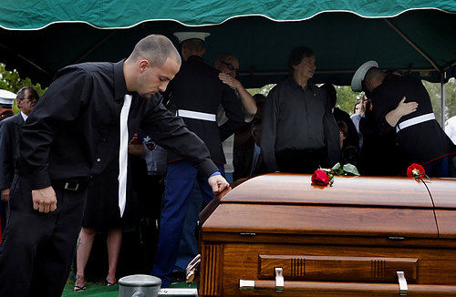 Third Place, Photographer of the Year/Large Market - Eric Albrecht / The Columbus Dispatch Jordan Dawson of Columbus gives a fist bump as his  final respect to high school friend Sgt. Jesse Balthaser who was killed serving in Afghanistan.