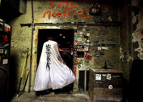 First Place, Photographer of the Year/Large Market - Lisa DeJong / The Plain DealerRich Kline heads towards the stage with his cape to perform with his band called Diamond Dogs at the Phantasy Nite Club in Lakewood.  Kline's band is a David Bowie tribute band and is performing songs from Bowie during his Ziggy Stardust days. Kline dresses in many of Bowie's incarnations during his live shows.