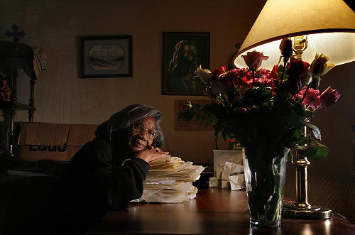 Third Place, Photographer of the Year/Large Market - Eric Albrecht / The Columbus Dispatch Johne Nichols of Columbus rests her head on her manuscript Path to Eternal Life which she hoped to publish as a book . She paid a company 1600 dollars for a computer to help with the publishing of the book but never received  the computer . The attourney generals office is suing  on her behalf and others who were ripped off by the company.
