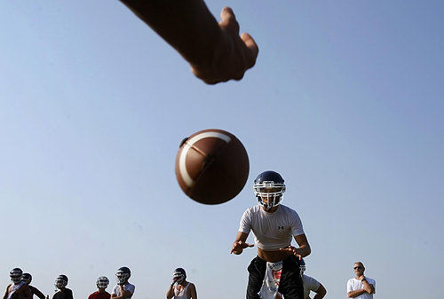 Third Place, Photographer of the Year/Large Market - Eric Albrecht / The Columbus DispatchAfter voters passed a levy returning sports to Grove City High School. Luke Smurthwaite takes a snap in practice after not having played football for a year.