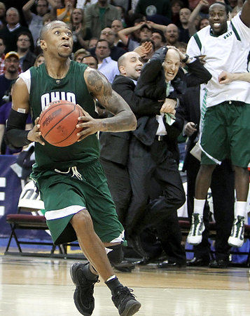 Second Place, Sports Action - John Kuntz / The Plain Dealer Ohio's Armon Bassett prepares for a dunk, and the Bobcats bench celebrates in the final seconds of overtime in the MAC Tournament men's basketball final Saturday at The Q. 