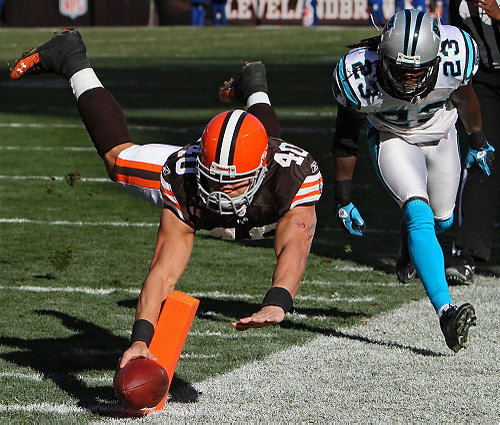 Award of Excellence, Sports Action - Ed  Suba Jr / Akron Beacon JournalCleveland Browns running back Peyton Hillis leaps past Carolina  Panthers safety Sherrod Martin and into the end zone on a 9-yard touchdown run during the Browns 24-23 victory over the Panthers.