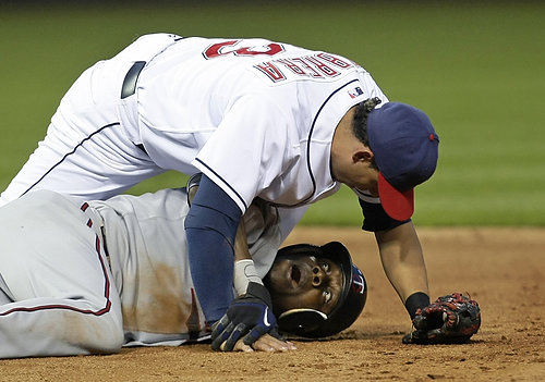 Award of Excellence, Sports Feature - Tony Dejak / Associated PressMinnesota Twins second baseman Orlando Hudson, bottom, looks up at Cleveland Indians shortstop Asdrubal Cabrera after stealing second base in the fifth inning of a baseball game in Cleveland. 