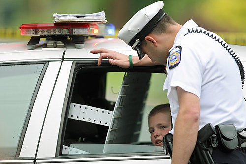 Second Place, Spot News (over 100,00) - Kyle Robertson / The Columbus DispatchColumbus Police officer talks to a child after he tried to take a gun from a cop and chase after the suspect who shot his step-father in a shooting on North Burgess street in the Hilltop. 