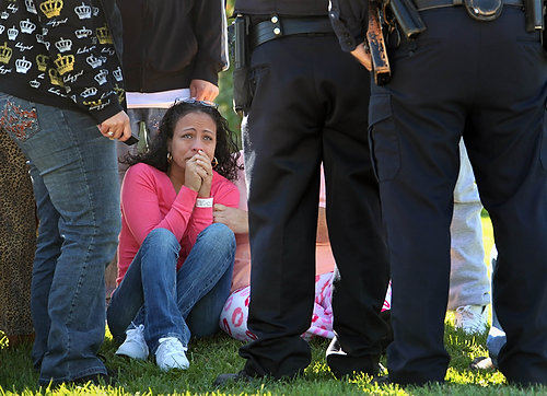 Third Place, Spot News over 100,000 - Marvin Fong / The Plain DealerLydia Morales, a relative of one of the two victims killed at the ParkOhio Products plant in Cleveland cries as police talk to family and friends.