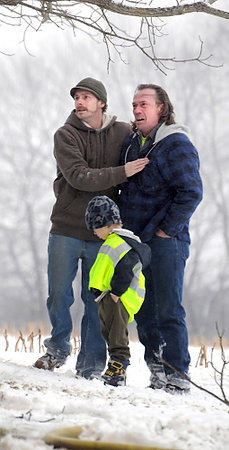 Third Place, Spot News Under 100 - Patricia Schaeffer / The (Lisbon) Morning JournalJason Snyder comforts his brother-in-law, Larry Fields, as firefighters try to extinguish a blaze at a log cabin where Fields resides. The historic log cabin was built circa 1874 and originally stood in the square in Unity. One of four log cabins now on the 270-acre Hoffstot Homestead, it was a total loss. The farm is part of Ohio's historic wilderness preservation land. 