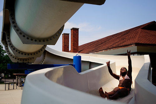 First Place, Student Photographer of the Year - Joel Hawksley / Ohio UniversityDanasia Walton, 11, of Grand Rapids, goes down the slide at Martin Luther King Park on Monday, July 5, 2010. Several local pools opened today after local residents and business raised the funds needed to staff them for the summer.