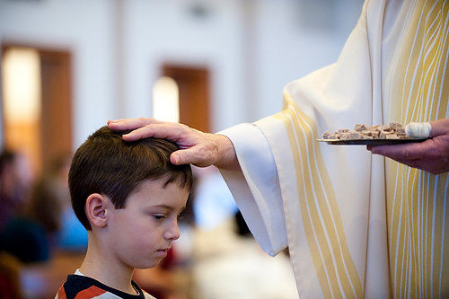 First Place, Student Photographer of the Year - Joel Hawksley / Ohio UniversityHenry Walsh, 8, receives a pat on the head from Father Holler during communion at Sunday mass, signifying a blessing, as Walsh is not yet receiving communion.