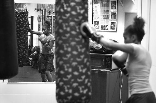 Second Place, Sports Picture Story - Carrie Cochran / Cincinnati EnquirerRaynesha Robinson, 13, of Millvale, works the punching bag at the Millvale Recreation Center. Her father is making her come to the gym as he tries to teach her focus and discipline. She was getting into trouble at school and was getting bad grades. 