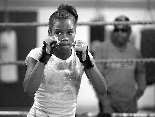 Second Place, Sports Picture Story - Carrie Cochran / Cincinnati EnquirerRay Robinson, 64, of Millvale, keeps on Raynesha as she shadow boxes. "She's gonna hang with me. She's not going to be hanging with her friends," he said. Raynesha's grades are slipping and Ray believes its because she had been hanging around kids from the neighborhood. 