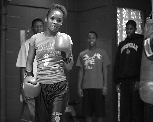 Second Place, Sports Picture Story - Carrie Cochran / Cincinnati EnquirerA crowd of boys gather around Raynesha to watch as she starts to get into a groove during practice, hitting whatever her dad throws up at her. She's been in the gym almost everyday now, while most of the boys come in inconsistently. "Most of the boys in the neighborhood start out at the gym, but then they'll see how much hard work it is, and then they'll stop," said Ray Robinson.