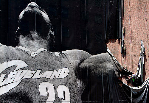 - 1st place, Team Picture Story - Lynn Ischay / The Plain DealerThree days after James' announcement, the giant Nike Witness mural was removed from a building across the street from Quicken Loans Arena, where James played for seven years.  Its removal marked the end of the LeBron James era in Cleveland.  