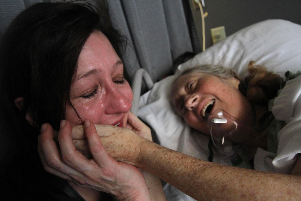 First place, Feature  - Chelsie Corso / Kent State UniversityChristina Marten is comforted by her older sister Sarah, at a nursing home in Hollywood, California.  Suffering from stage 4 colon cancer, Sarah died just days after this image was taken.