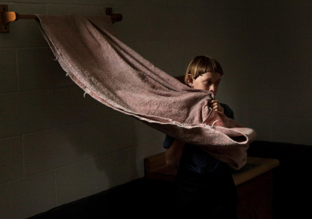 Third place, Feature - Marvin Fong / The Plain DealerAn Amish child wipes his face after washing his hands at his school in Bergholz, OH.   Several children in this school have parents convicted and sentenced for federal hate crimes involving beard and hair cutting attacks.  The community ponders a future without them.  