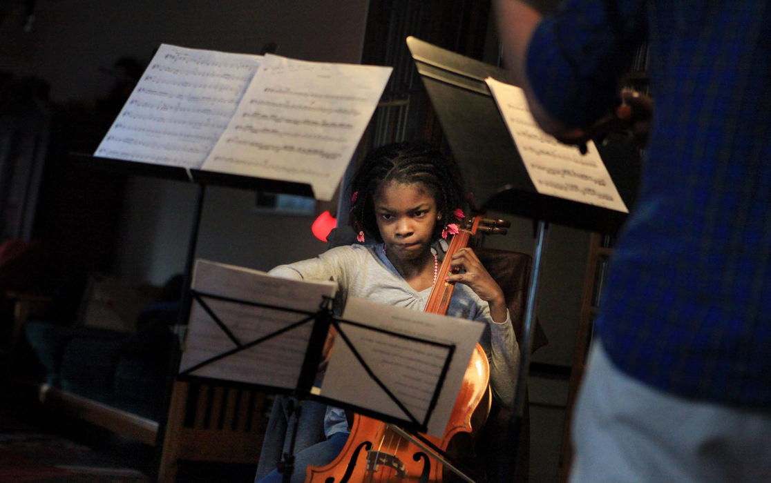 Second place, Feature Picture Story - Gus Chan / The Plain DealerSaria Neal plays the Pachelbel Canon in the home of her instructor Isabel Trautwein.  Trautwen, a violinist with the Cleveland Orchestra, is the artistic director of El Sistema @ Rainey.  Trautwein will bring students to her home if she thinks they will benefit from the special attention.