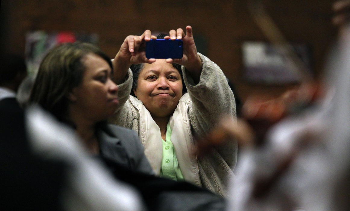 Second place, Feature Picture Story - Gus Chan / The Plain DealerSheila Sudberry videotapes her granddaughter, Jamiyah Dotson, during a Thursday afternoon performance of El Sistema @ Rainey.  The youth orchestra performs weekly to give the students confidence to play in front of an audience.