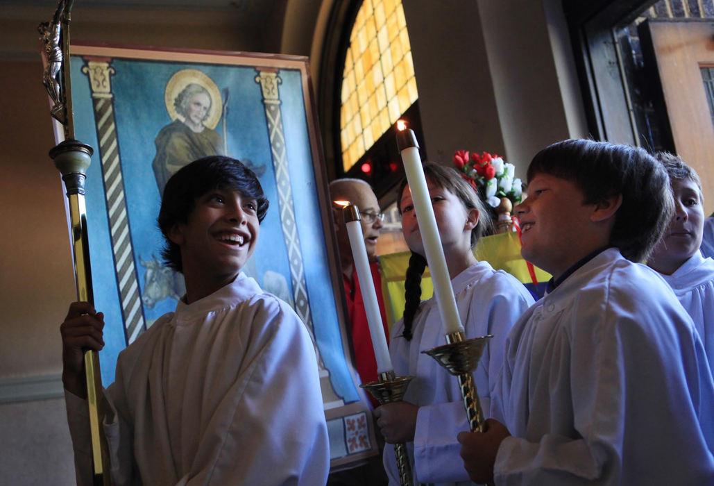 First place, News Picture Story - Gus Chan / The Plain DealerAlex Chura, holds the crucifix as he waits to lead the procession for the reopening mass of St. Wendelin Catholic Church.  St. Wendelin closed May 23, 2010, as part of a diocese-wide downsizing.  