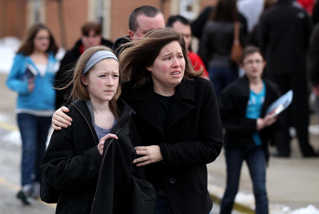 Second place, News Picture Story - Marvin Fong / The Plain DealerNervous parents pick up their children at Chardon Middle School after shootings took place at nearby Chardon High School.  Three students died and three others were injured.  