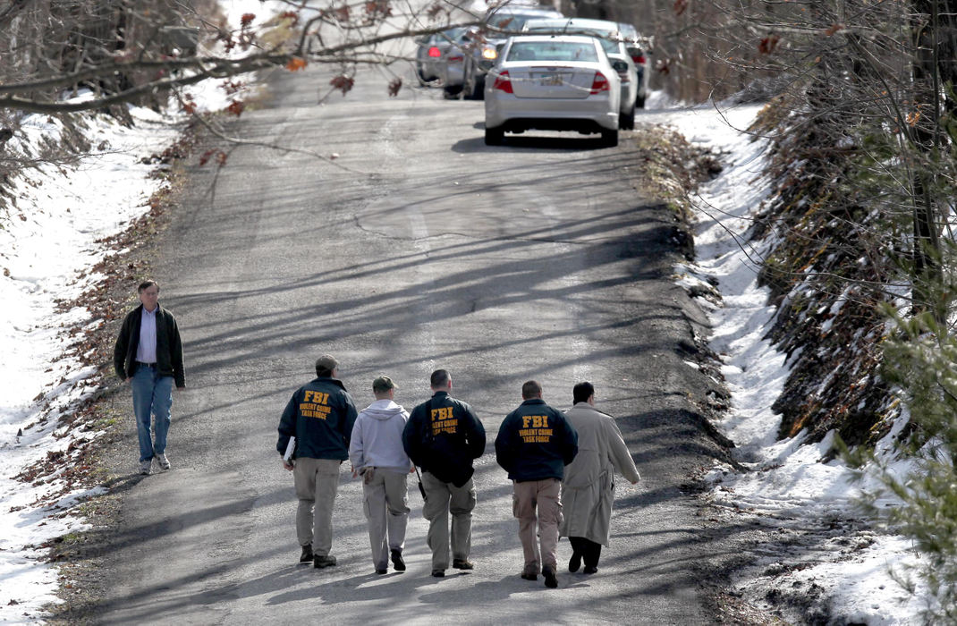 Second place, News Picture Story - Marvin Fong / The Plain DealerLaw enforcement officials investigate property along Wilder Road in Chardon, OH.  They are looking for evidence connected to T.J. Lane, the suspect in the Chardon High School shootings.     