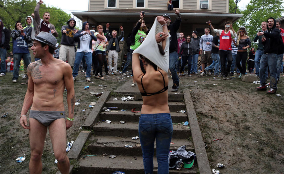 Third place, News Picture Story - Coty Giannelli / Kent State UniversityCaleb Jensen and Chelsea Cox strip down to their underwear, as partygoers cheer. College Fest is an annual block party on College Avenue in Kent. Partygoers come to dance and drink, starting in the early morning and throughout the night.