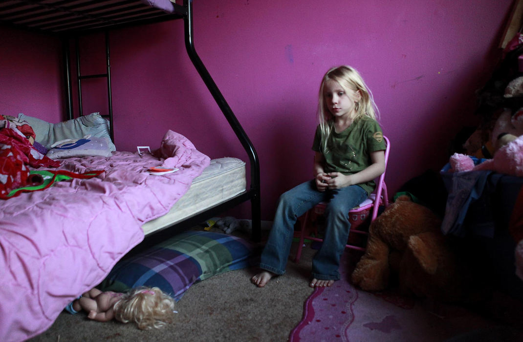 Award of Excellence, News Picture Story - Leigh Taylor / Cincinnati EnquirerJessica Maus, 5, sits in the room that she shares with her two sisters and her sister's two daughters. Jessica and her sisters Cherr, 11, and Victoria, 10, lives with their sister, Ashley Tinker, 22, and Ashley's daughters Emerald, 6, and Ava, 3, in a 2-bedroom apartment in Westwood.  Ashley has had custody of her sisters since October, and they came to her with very little.  In addition to raising the girls, Ashley also attends college.   The family wishes for Christmas presents for the girls and clothes because most of the clothes they came with are too small.  Cherr wishes for a camera and Jessica and Victoria would like dolls, toys and games.  This is part of the Wish List series, which highlights needy people in the area and then asks for reader donations.
