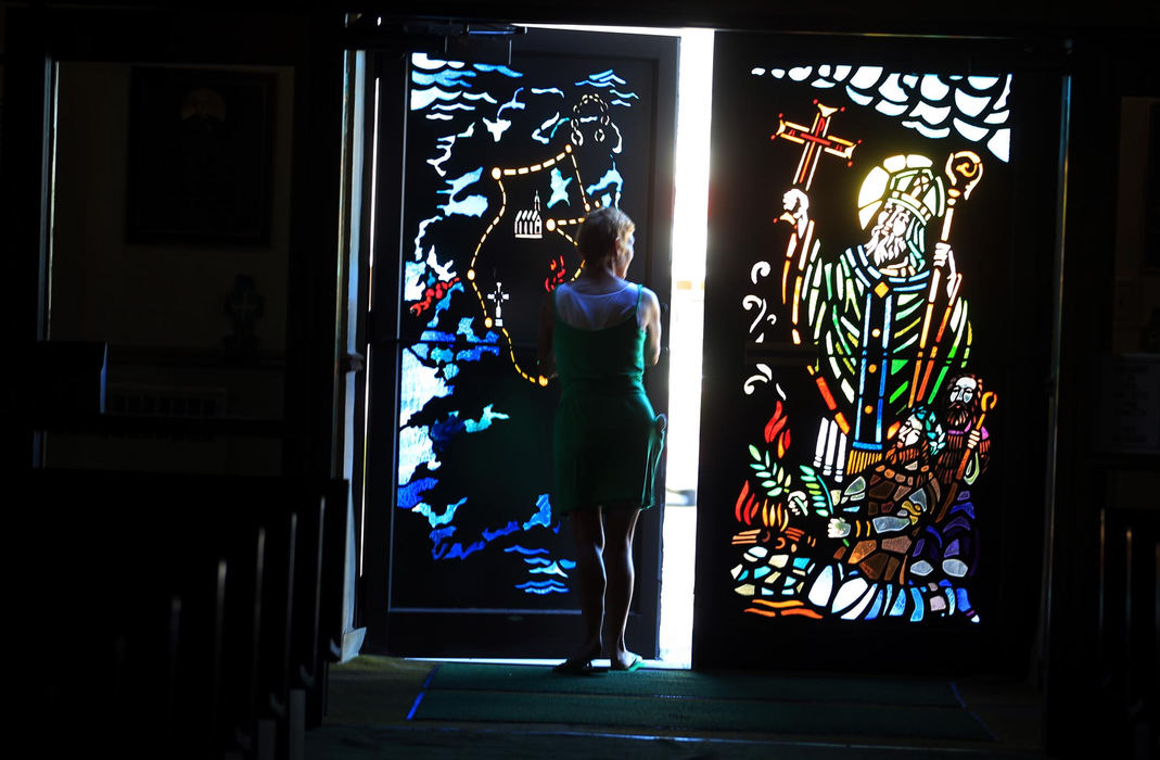 First place, News Picture Story - Gus Chan / The Plain DealerPatricia Schulte-Singleton props open the doors of St. Patrick Catholic Church for the first time in more than two years .  St. Patrick was reopened after parishioners appealed it's closing to the Vatican.
