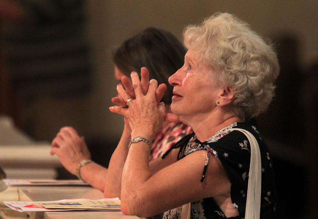 First place, News Picture Story - Gus Chan / The Plain DealerMary Zrebiec, tears up as she prays at the altar of St. Casimir Catholic Church with her friend, Christine Cummings, for the first time in more than two years.  Zrebiec was born, baptized, made her first communion and married in the church.