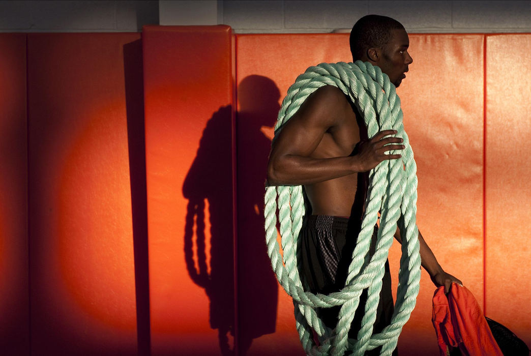 First place, James R. Gordon Ohio Understanding Award - Gary Harwood / Kent State UniversityMassillon Tigers Marcus Whitfield carries a rope out of the indoor practice facility after an early morning conditioning practice that began at 5am at Washington High School.