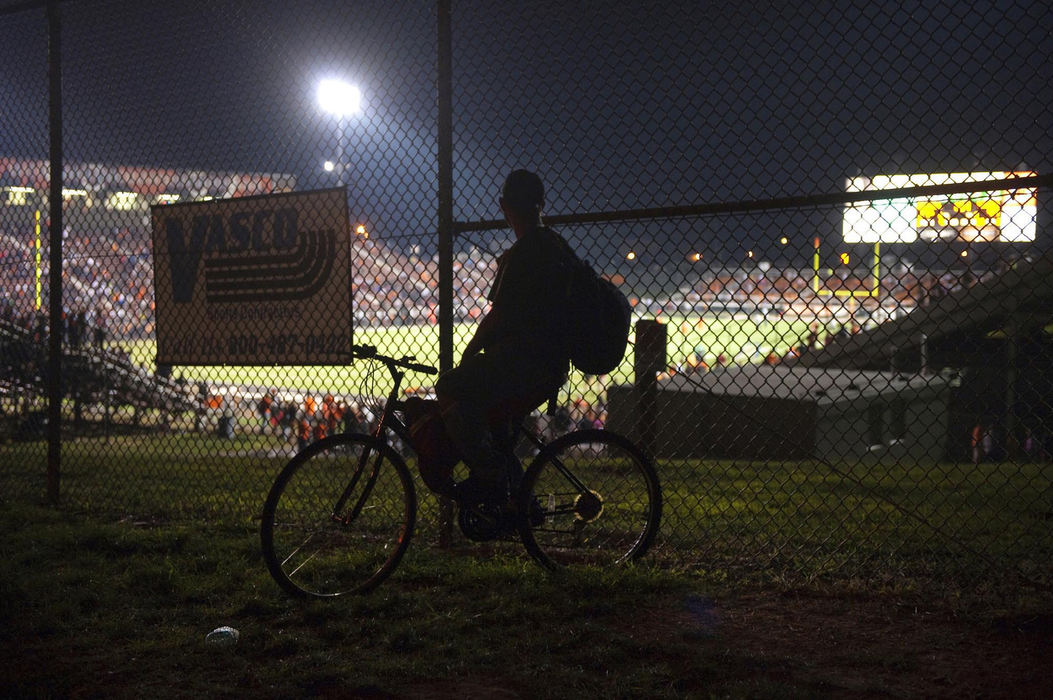 First place, James R. Gordon Ohio Understanding Award - Gary Harwood / Kent State UniversityA man on his bike, stops to watch a game at Paul Brown Stadium