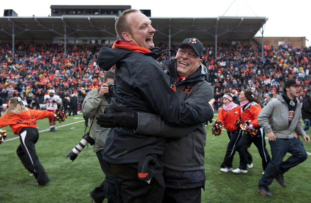 First place, James R. Gordon Ohio Understanding Award - Gary Harwood / Kent State UniversityWith a victory assured, head coach Jason Hall and Booster President Ron Thornberry embrace after the two men ran onto the field in the closing seconds of the 122nd game between Massillon Tigers and Canton McKinley Bulldogs. 