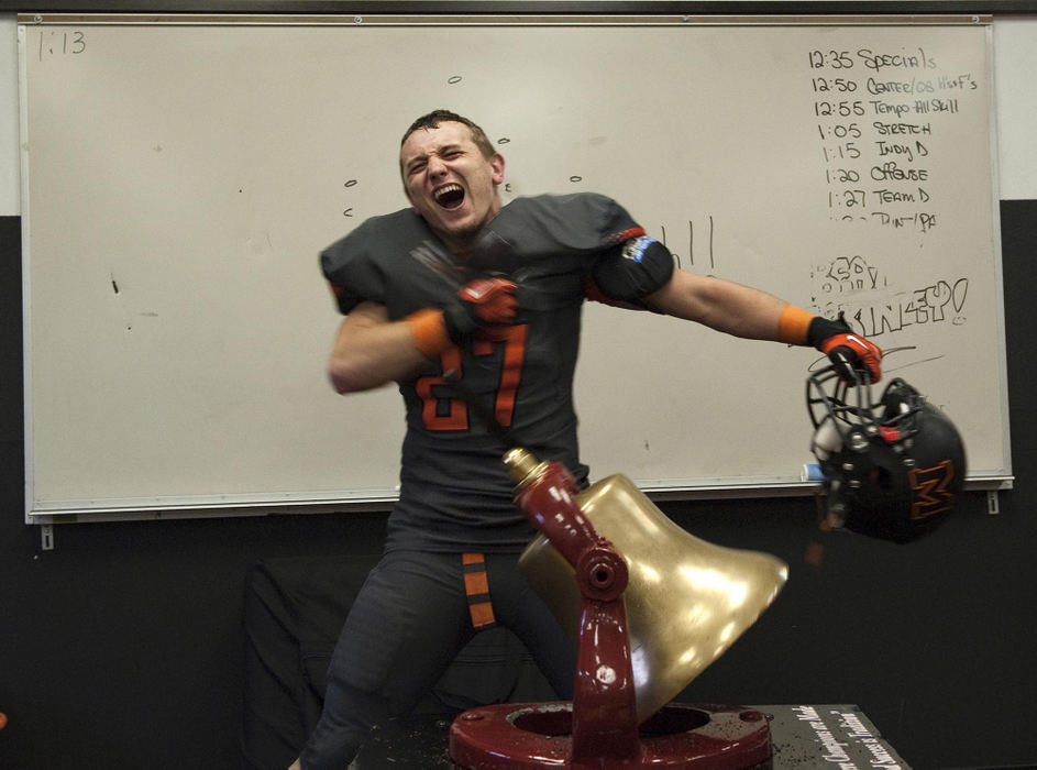 First place, James R. Gordon Ohio Understanding Award - Gary Harwood / Kent State University Senior Dillon Cowan rings the Victory Bell with energy and emotion after the Tigers defeated the McKinley Bulldogs. The Tigers lost the three previous games, so this was his first, and final chance to experience the satisfaction of ringing the bell and knowing the bell, symbolic of the rivalry, has been returned to Massillon.