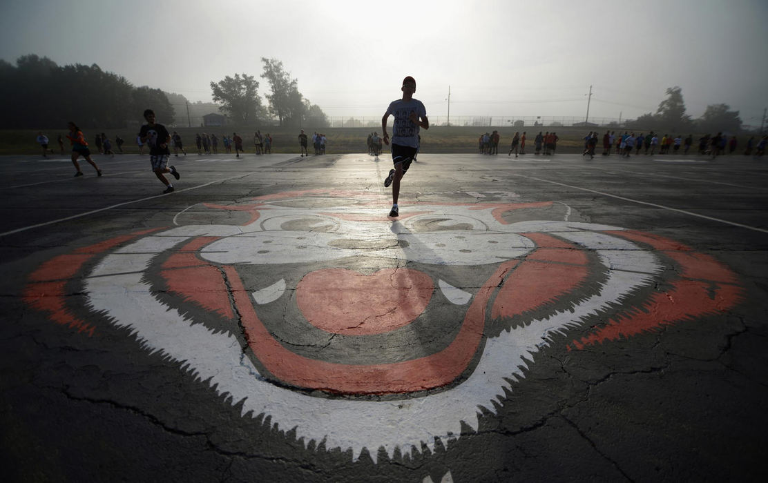 First place, James R. Gordon Ohio Understanding Award - Matt Hafley / Kent State UniversityMembers of the Tiger Swing Band run laps on a foggy morning before practice. While the football team practices on the field, the band hold practice on a nearby parking lot that is prepared for their needs.