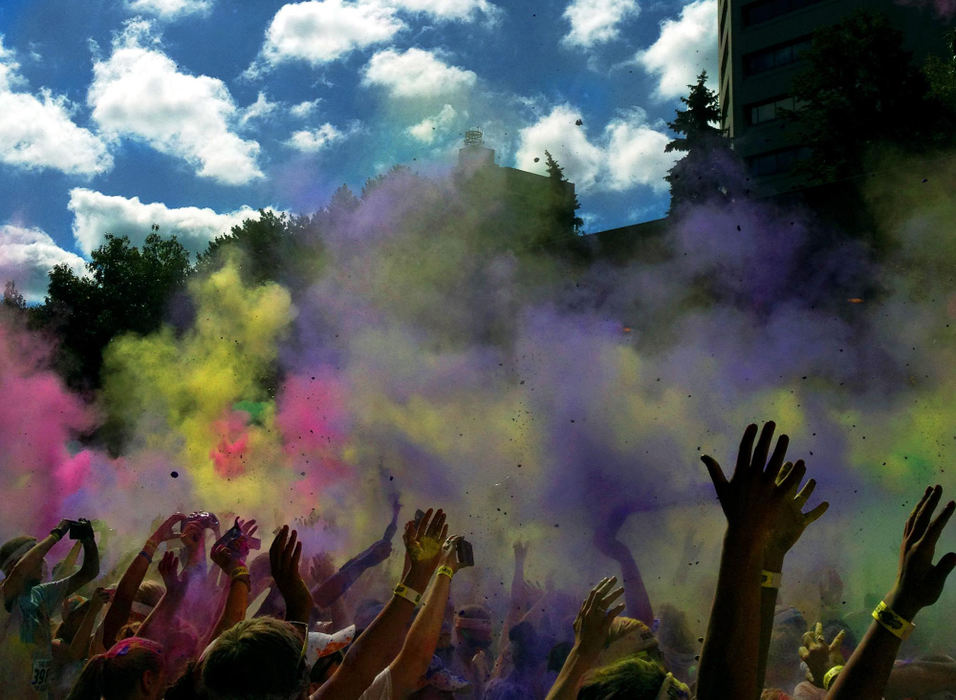 Second place, Pictorial - Kyle Robertson / The Columbus DispatchThe Color Run participants toss up color chalk while celebrating the end of the 5K run on West Long Street in Columbus. Officials estimated that more than 12,000 people participated in the event, which featured runners passing through several color stations where they were doused with pink, blue, yellow and orange chalk. 