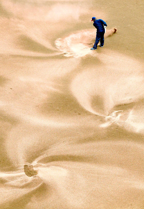 Award of Excellence, Pictorial - Chuck Crow / The Plain DealerCleveland Indians head groundskeeper Brandon Koehnke created practically perfect swirls while spreading out a drying agent on the infield before the first game of a double header. 