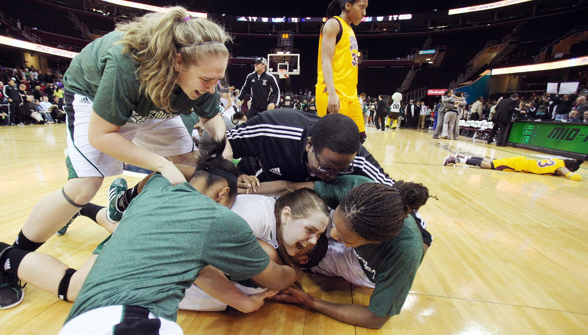 Award of Excellence, Photographer of the Year - Large Market - John Kuntz / The Plain DealerEastern Michigan players pile on Paige Redditt after she scored the winning basket with a few seconds left on the clock against Central Michigan during the Mid-American Conference championship game March 10, 2012 at Quicken Loans Arena. 