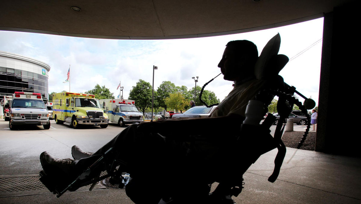 Award of Excellence, Photographer of the Year - Large Market - John Kuntz / The Plain DealerScott waits outside the lobby of Fairview Hospital for his ride home after taking a series of tests in his arms checking nerve damage. Fedor, on vacation with his wife Kristi at her parent's lake cottage in Michigan, decided to take a quick dip in the lake before dinner on a hot Summer evening.  Unaware of the drop in the lake level, he dove in hitting his head on the bottom severing his spinal cord and changing his world forever.  