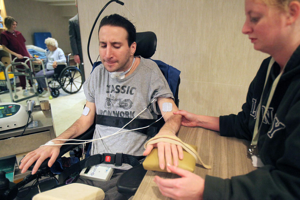 Award of Excellence, Photographer of the Year - Large Market - John Kuntz / The Plain DealerTrying so hard he gives himself a headache, Scott attempts to move his paralyzed arm in February 2010, while at the Rae-Ann Westlake nursing home.  It doesn’t budge.  