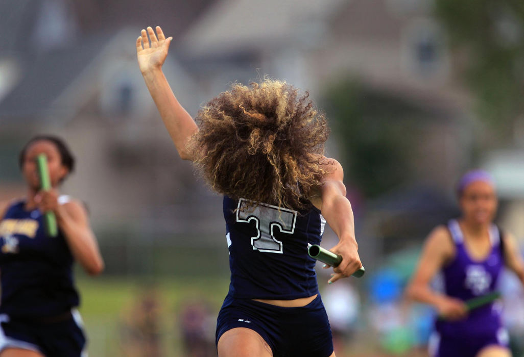 First place, Photographer of the Year - Large Market - Gus Chan / The Plain DealerLorain's Jocelynn Rogers crosses the finish line in a flurry of hair in the girls 4X200 meter relay in the regional track finals.  The Titans finished first but were disqualified for a bad baton exchange. 