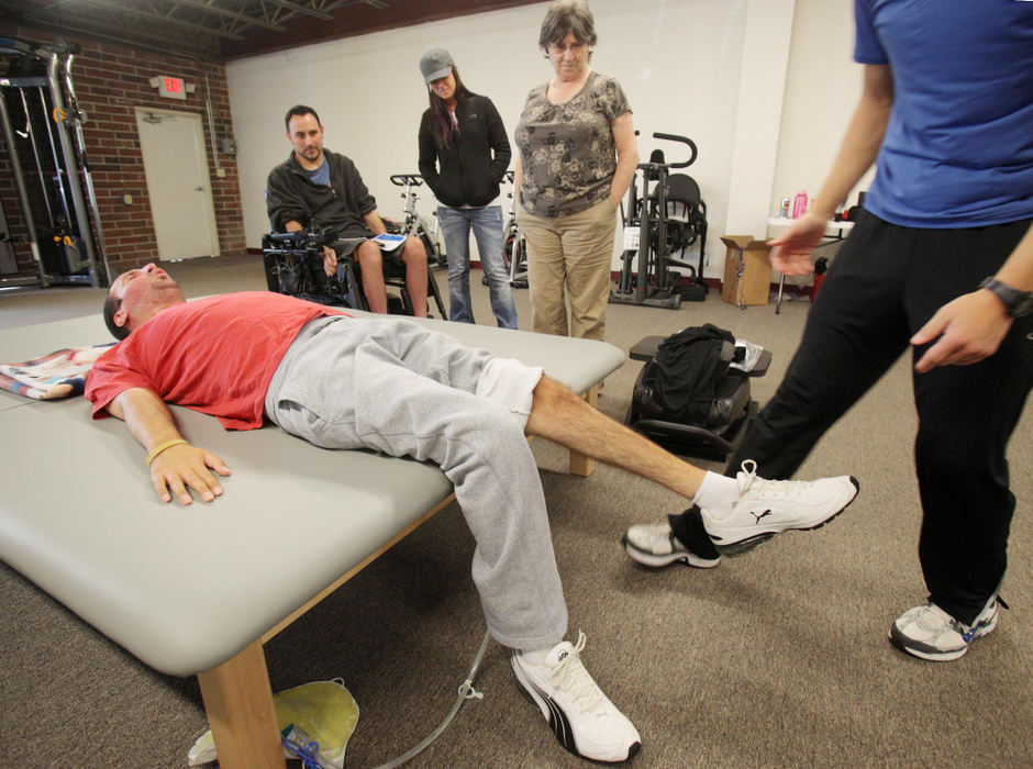 Award of Excellence, Photographer of the Year - Large Market - John Kuntz / The Plain DealerScott struggles at the gym to hold himself upright and sit without help. His determination has paid off. About a year ago, after weeks of repetitive exercise, he was able to lift his feet off the floor on his own — just a bit — for the first time.